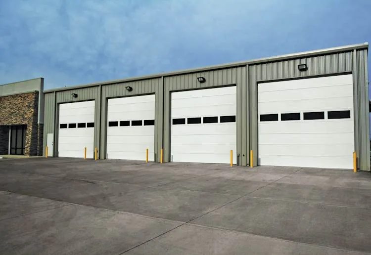 Commercial building with four white Hörmann 324S sectional doors